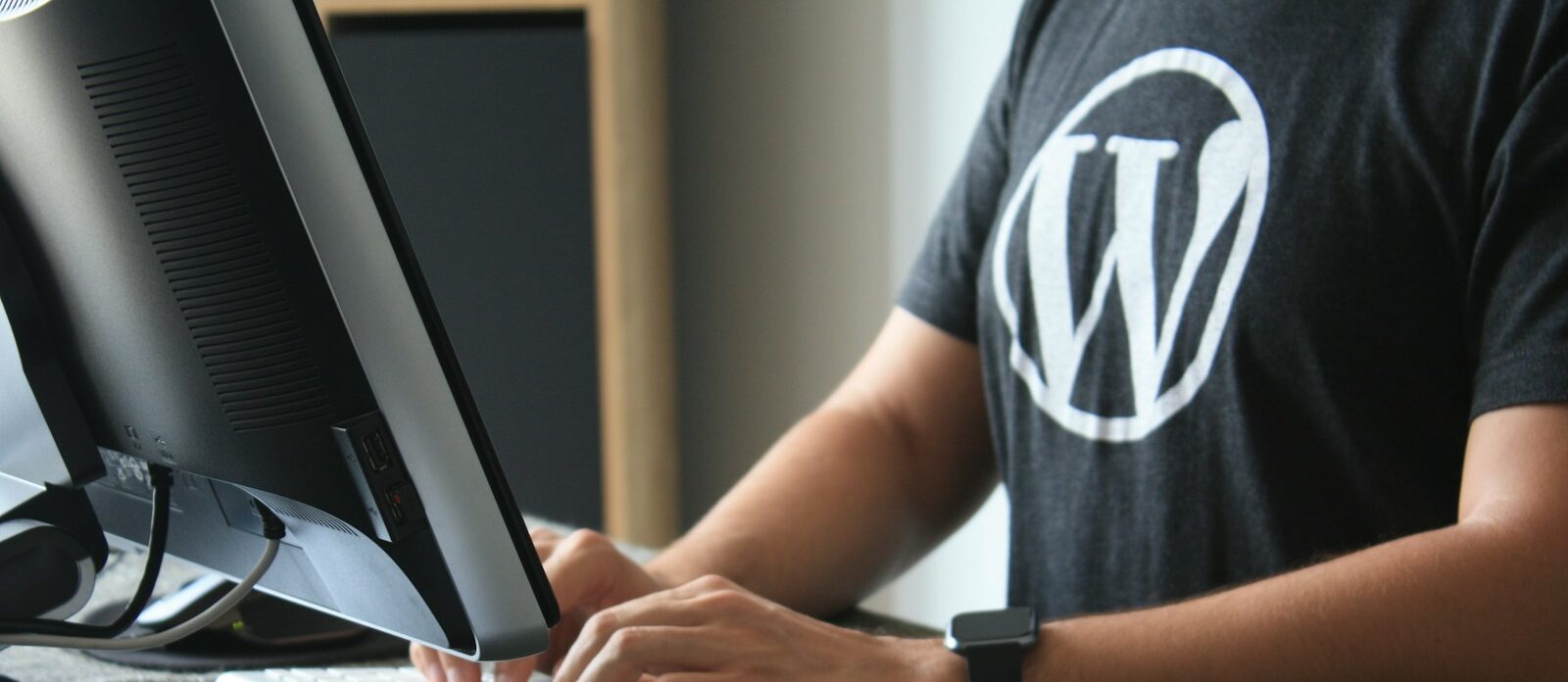 person in black and white t-shirt using computer